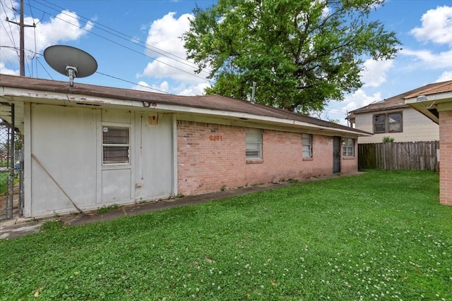 6201 Batterson St, Houston, TX 77026 - back of house with fence, a yard, and brick siding