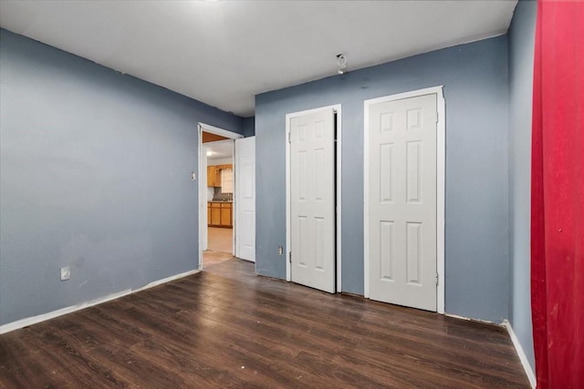 6201 Batterson St, Houston, TX 77026 - unfurnished bedroom featuring baseboards and wood finished floors