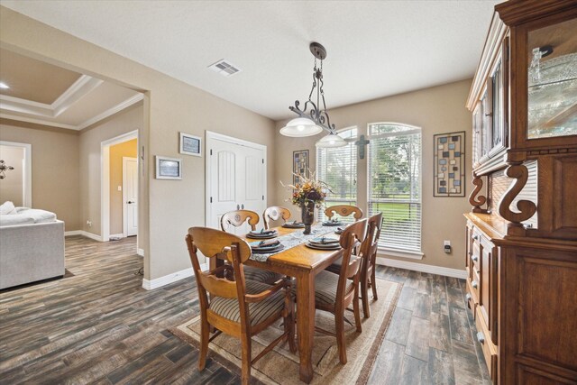 dining space with visible vents, ornamental molding, baseboards, and dark wood-style floors