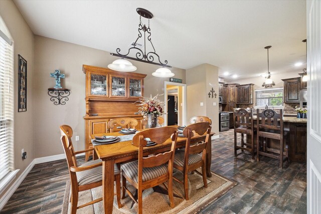 dining area featuring baseboards and dark wood-style floors
