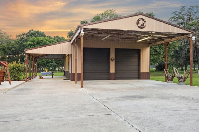 garage at dusk with a detached garage