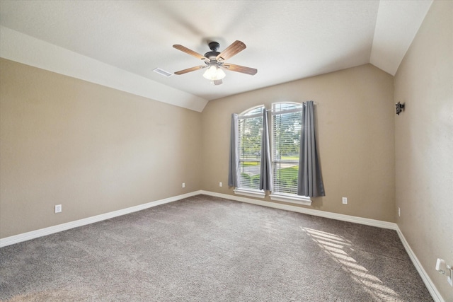 carpeted empty room with baseboards, ceiling fan, visible vents, and lofted ceiling