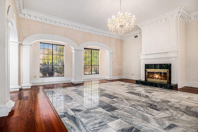 7415 Naremore Dr, Spring, TX 77379 - unfurnished living room with ornamental molding, a notable chandelier, hardwood / wood-style flooring, and a premium fireplace