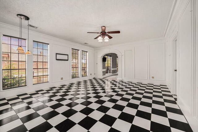 7415 Naremore Dr, Spring, TX 77379 - unfurnished room featuring a ceiling fan, visible vents, arched walkways, ornamental molding, and a decorative wall