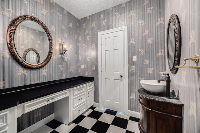 bathroom featuring tile patterned floors, vanity, and a textured ceiling
