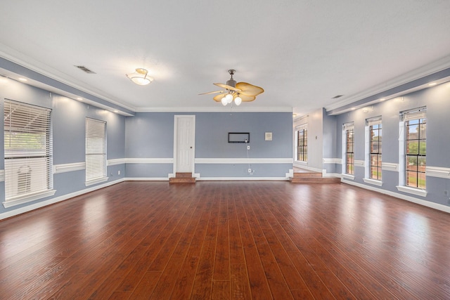 unfurnished living room with ceiling fan, visible vents, baseboards, ornamental molding, and dark wood-type flooring