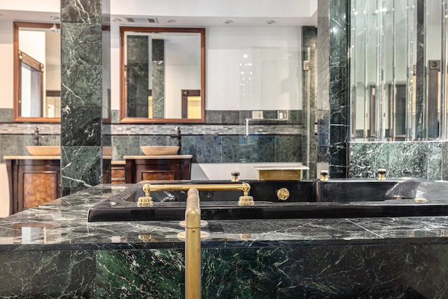 bathroom with vanity and a washtub