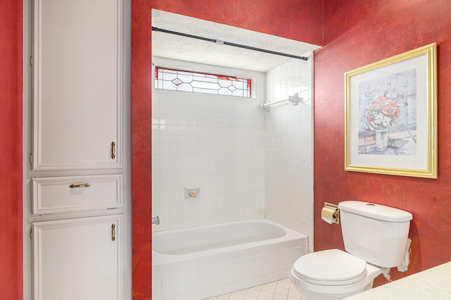 bathroom with toilet, tile patterned floors, and tub / shower combination