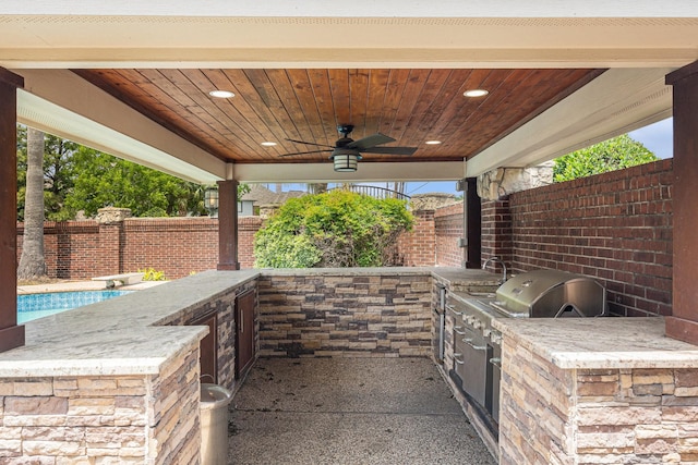 view of patio featuring an outdoor kitchen, a sink, ceiling fan, and a fenced backyard