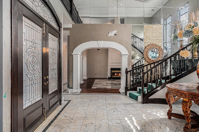 7415 Naremore Dr, Spring, TX 77379 - entryway with arched walkways, french doors, stairs, and a towering ceiling