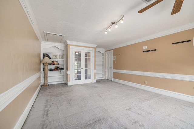 7415 Naremore Dr, Spring, TX 77379 - spare room with crown molding, a textured ceiling, french doors, and attic access