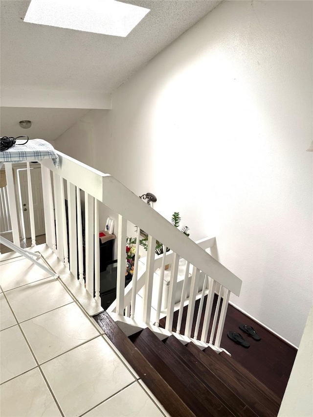 12606 Newbrook Dr, Houston, TX 77072 - staircase featuring vaulted ceiling with skylight