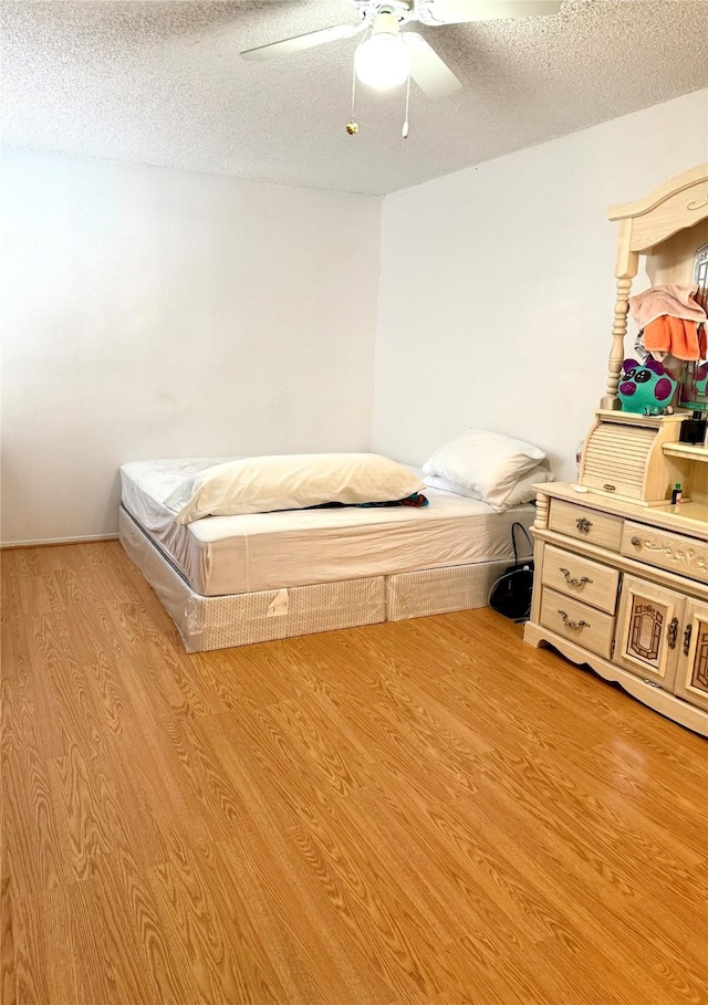 12606 Newbrook Dr, Houston, TX 77072 - bedroom with light wood-type flooring, a textured ceiling, and ceiling fan
