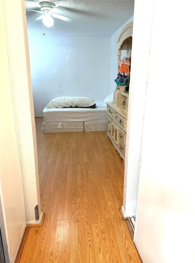 12606 Newbrook Dr, Houston, TX 77072 - hallway with light wood-type flooring and a textured ceiling