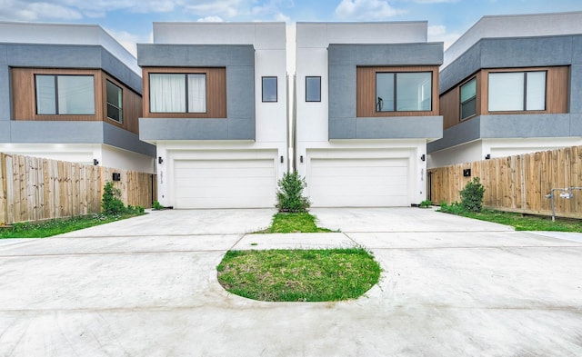 3515 Mcilhenny St, Houston, TX 77004 - view of front of property featuring stucco siding, a garage, fence, and driveway