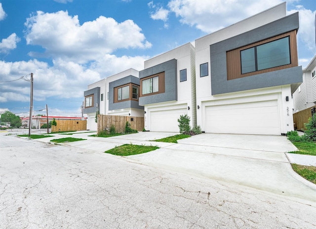 3515 Mcilhenny St, Houston, TX 77004 - contemporary home featuring an attached garage, driveway, and stucco siding