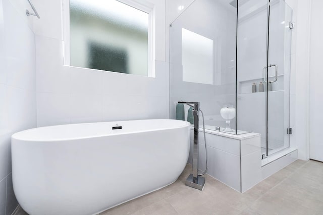 3515 Mcilhenny St, Houston, TX 77004 - bathroom featuring tile walls, a freestanding bath, and a shower stall