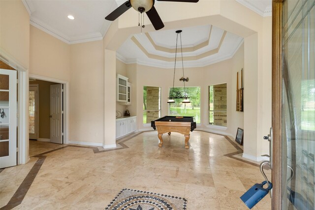 recreation room with ceiling fan, pool table, baseboards, ornamental molding, and a high ceiling