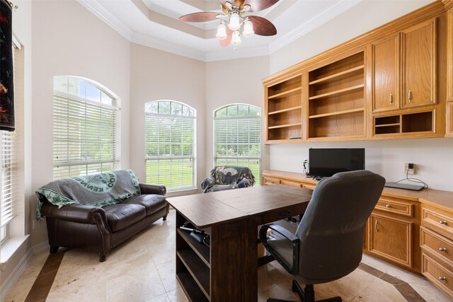 office space featuring built in study area, ornamental molding, a ceiling fan, and a wealth of natural light