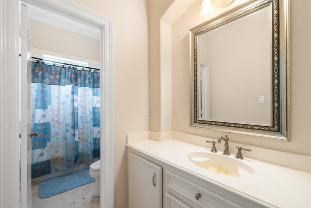 bathroom featuring toilet, a shower with curtain, and vanity