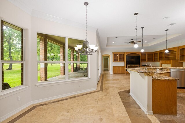 kitchen featuring crown molding, dishwasher, a raised ceiling, ceiling fan with notable chandelier, and an island with sink