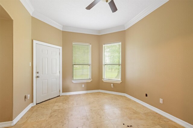 spare room featuring crown molding, arched walkways, baseboards, and ceiling fan