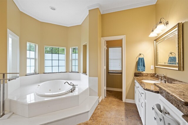 bathroom with crown molding, a jetted tub, baseboards, and vanity