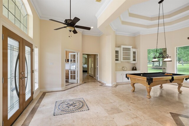 playroom with french doors, ornamental molding, and a high ceiling