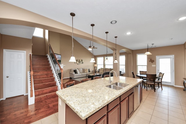 7603 Chimney Gap, Missouri City, TX 77459 - kitchen featuring pendant lighting, a sink, open floor plan, arched walkways, and a ceiling fan