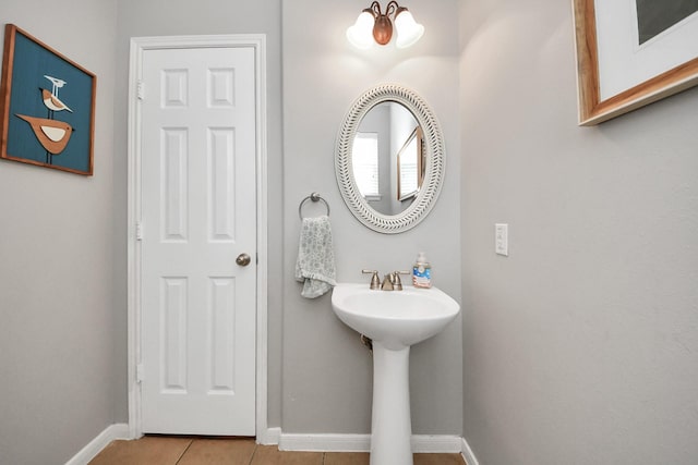7603 Chimney Gap, Missouri City, TX 77459 - bathroom featuring baseboards, a sink, and tile patterned floors
