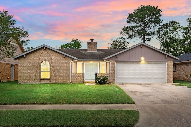 ranch-style house with a garage, a chimney, concrete driveway, and brick siding