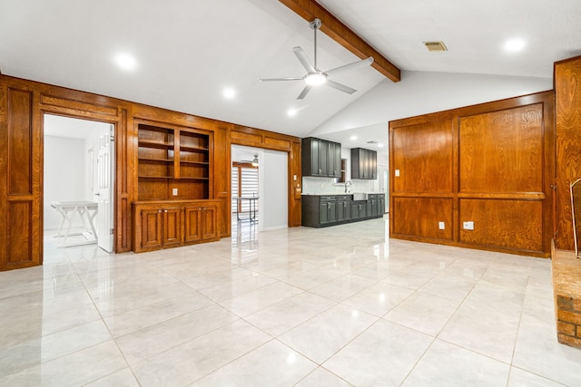 unfurnished living room featuring a sink, lofted ceiling with beams, a ceiling fan, and visible vents