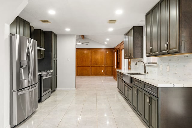 kitchen with visible vents, a ceiling fan, a sink, appliances with stainless steel finishes, and backsplash