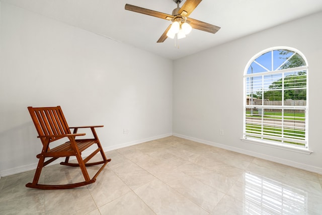 unfurnished room with light tile patterned floors, baseboards, and a ceiling fan