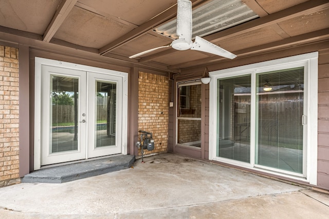 exterior space featuring brick siding, a ceiling fan, a patio area, and french doors