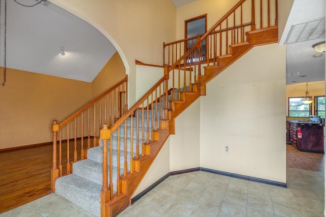 7739 County Road 684, Sweeny, TX 77480 - stairway with arched walkways, baseboards, and tile patterned flooring