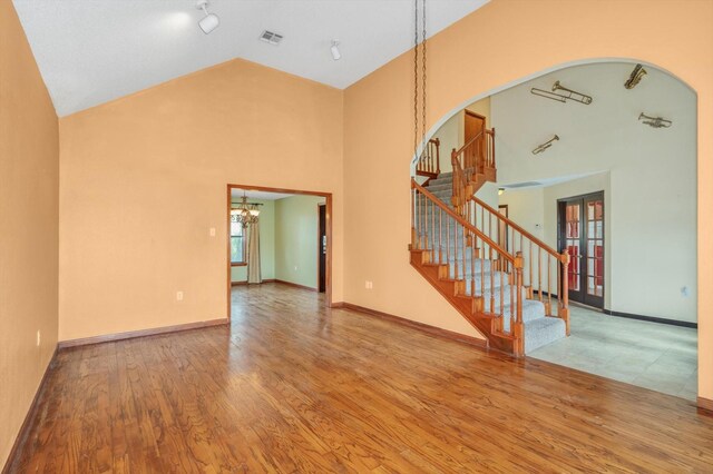 7739 County Road 684, Sweeny, TX 77480 - interior space featuring an inviting chandelier, stairway, french doors, and wood finished floors