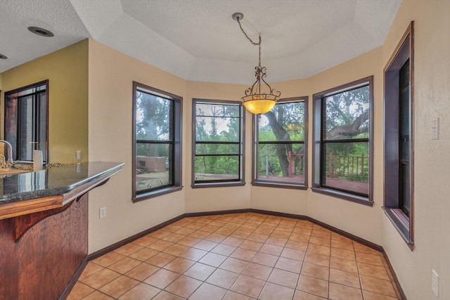 7739 County Road 684, Sweeny, TX 77480 - unfurnished dining area with a textured ceiling, plenty of natural light, and light tile patterned flooring