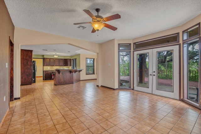 7739 County Road 684, Sweeny, TX 77480 - unfurnished living room with a wealth of natural light, a textured ceiling, and visible vents