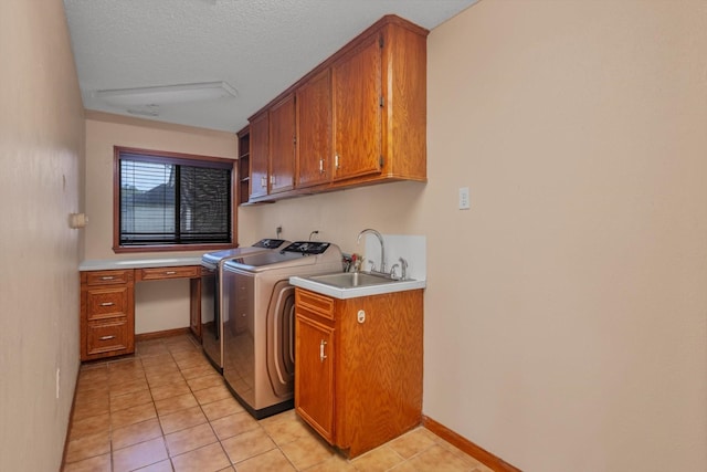 7739 County Road 684, Sweeny, TX 77480 - washroom with cabinet space, washing machine and dryer, light tile patterned flooring, and a textured ceiling