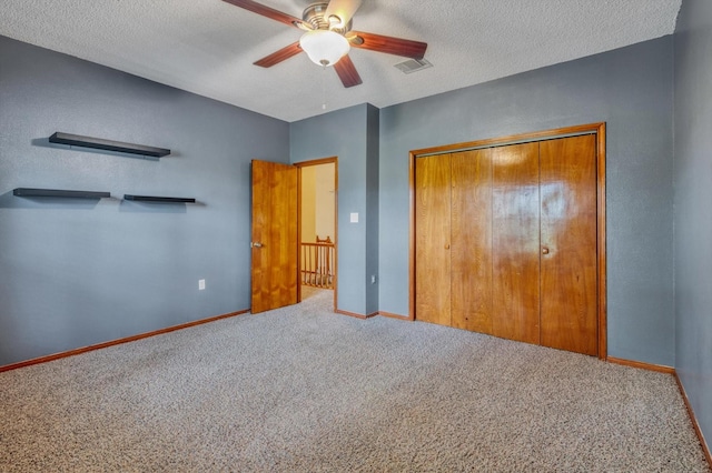 7739 County Road 684, Sweeny, TX 77480 - unfurnished bedroom with carpet floors, a textured ceiling, baseboards, and a closet