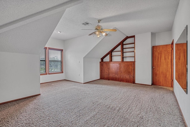 7739 County Road 684, Sweeny, TX 77480 - additional living space with carpet flooring, ceiling fan, visible vents, a textured ceiling, and vaulted ceiling