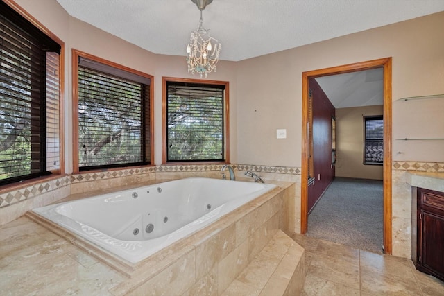 7739 County Road 684, Sweeny, TX 77480 - full bath featuring a whirlpool tub, tile patterned floors, a notable chandelier, and vanity