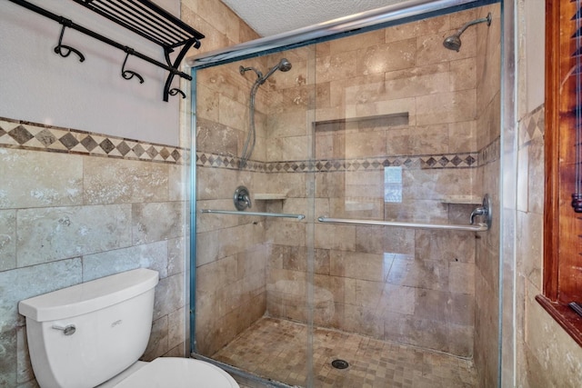 7739 County Road 684, Sweeny, TX 77480 - full bathroom featuring tile walls, a shower stall, and a textured ceiling