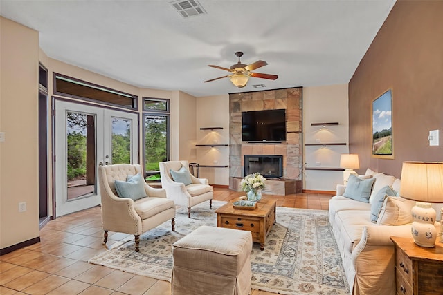 7739 County Road 684, Sweeny, TX 77480 - living room featuring a ceiling fan, light tile patterned floors, and a tiled fireplace