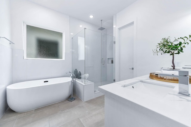 full bathroom featuring double vanity, a soaking tub, and a shower stall