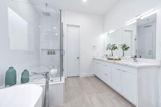 full bathroom featuring a sink, a soaking tub, a shower stall, and double vanity