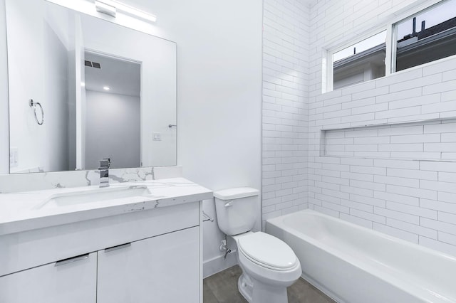 bathroom with vanity, visible vents, toilet, baseboards, and shower / bath combination