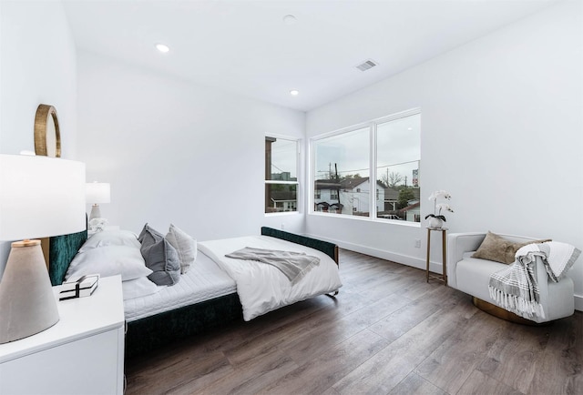 bedroom with recessed lighting, baseboards, visible vents, and wood finished floors