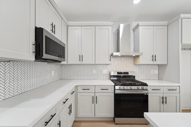 5013 Golden Forest Dr, Houston, TX 77091 - kitchen featuring stainless steel appliances, wall chimney exhaust hood, tasteful backsplash, and light countertops